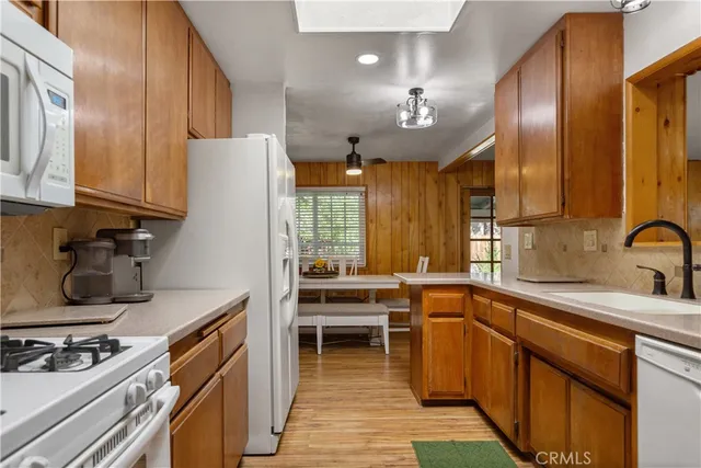 a kitchen with stainless steel appliances a sink stove and cabinets