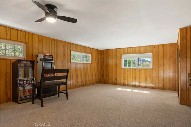 a view of a livingroom with furniture and ceiling fan