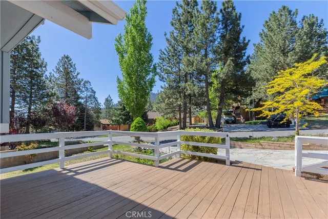 a view of a deck with chairs and wooden fence