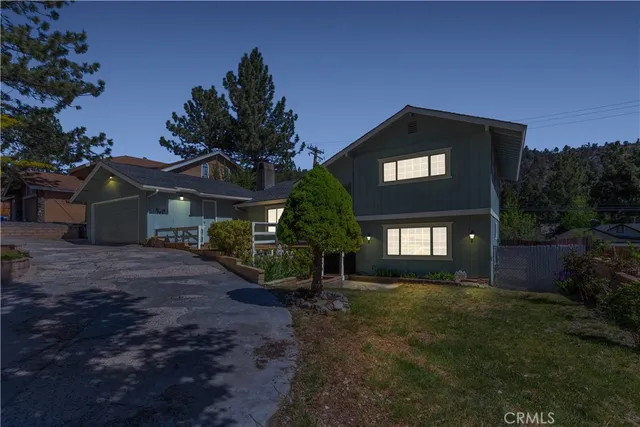 a view of a house with a yard and potted plants