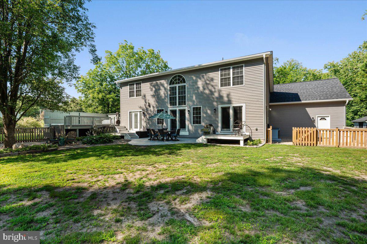 290 Swaggers Point Road Solomons, MD 20688 - Photo 54 of 55 a view of a house with a patio and a yard