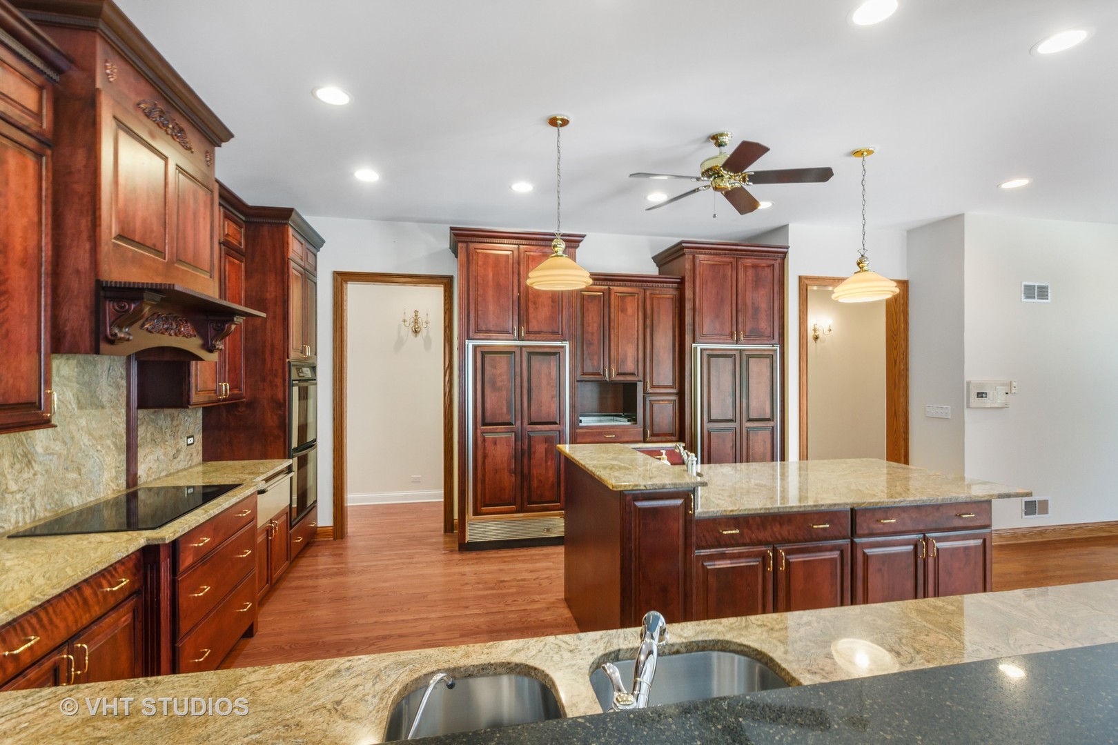 8702 Bull Valley Road Bull Valley, IL 60098 - Photo 11 of 30 a kitchen with stainless steel appliances kitchen island granite countertop a refrigerator a sink a stove and wooden cabinets