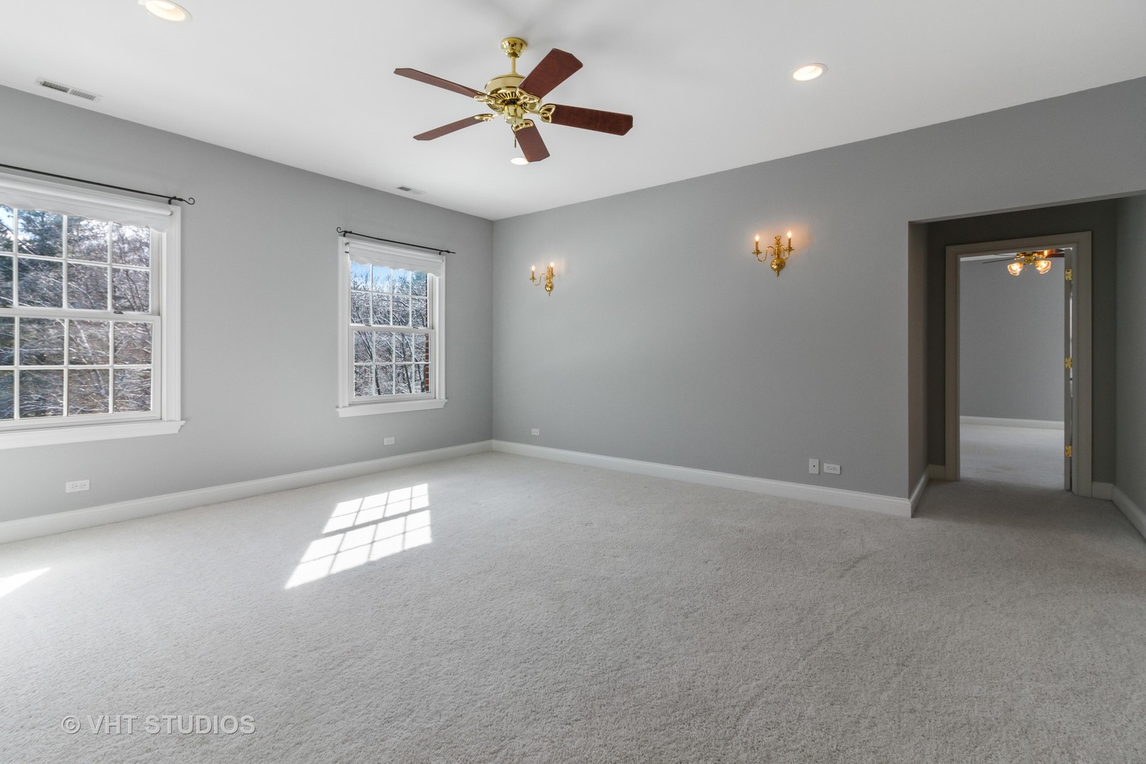 8702 Bull Valley Road Bull Valley, IL 60098 - Photo 21 of 30 an empty room with windows and ceiling fan