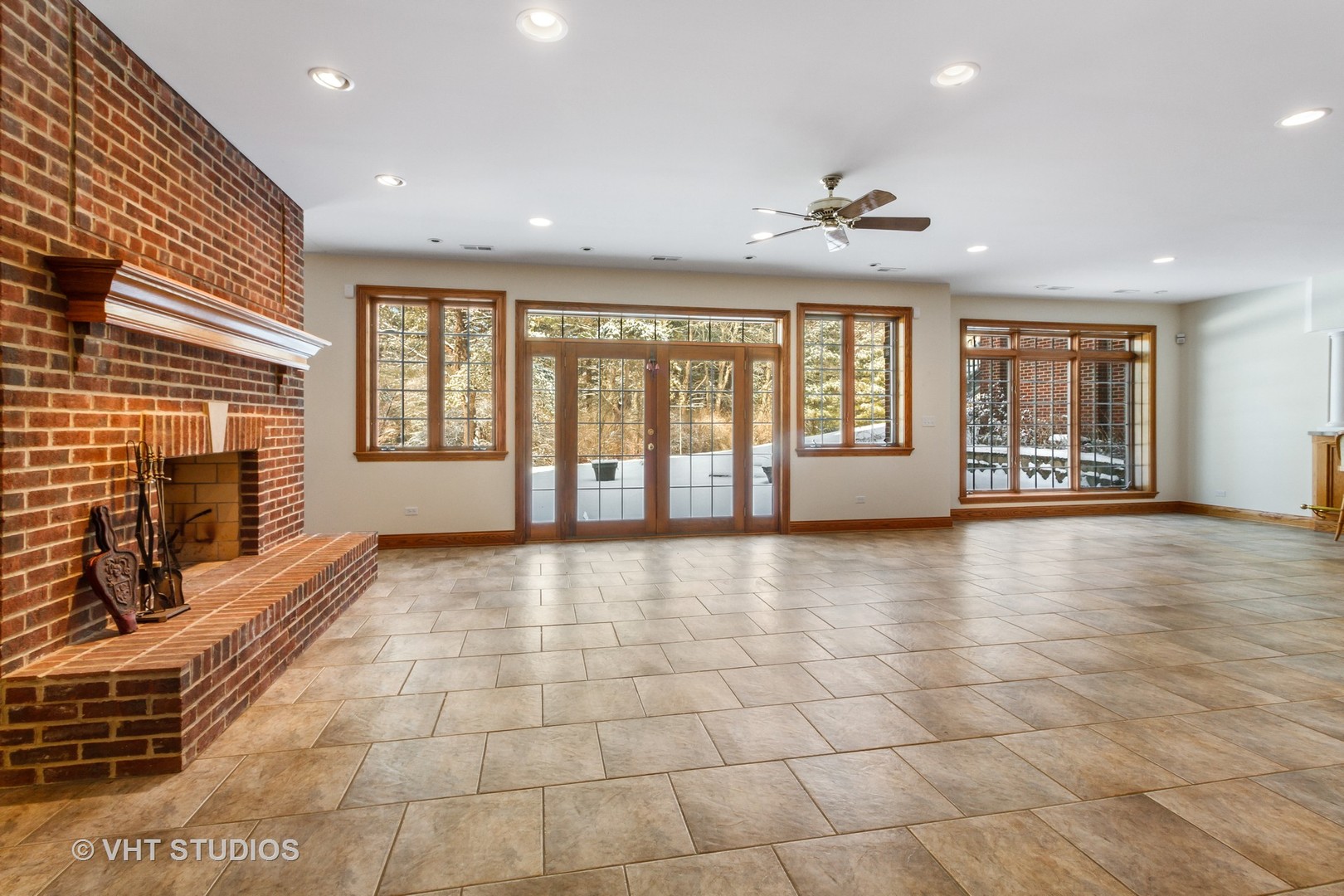 8702 Bull Valley Road Bull Valley, IL 60098 - Photo 26 of 30 a view of an empty room with a fireplace and wooden floor