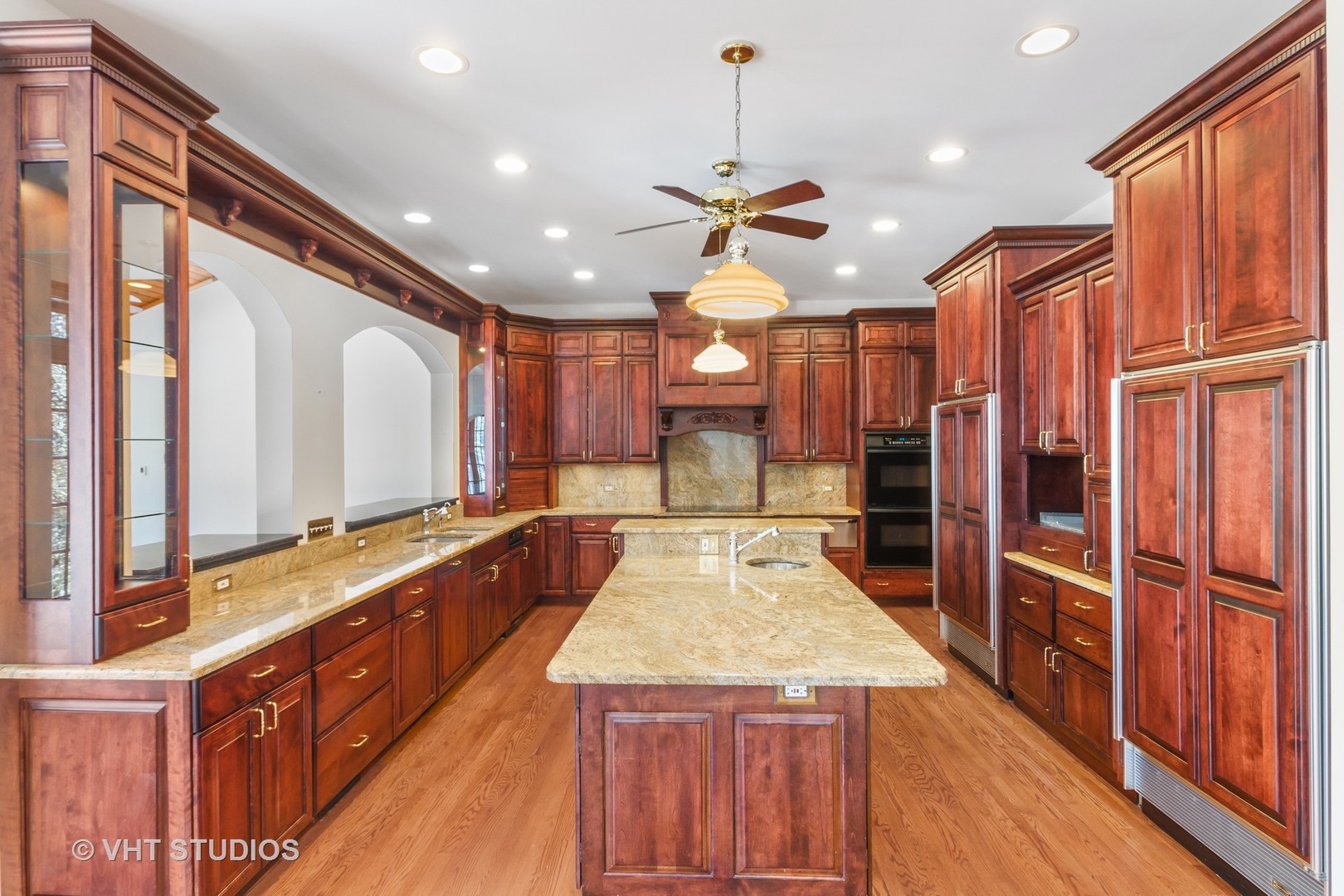 8702 Bull Valley Road Bull Valley, IL 60098 - Photo 9 of 30 a large kitchen with kitchen island a large counter space a sink appliances and cabinets