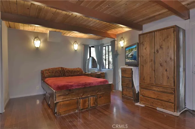 a room with pool table and wooden floor