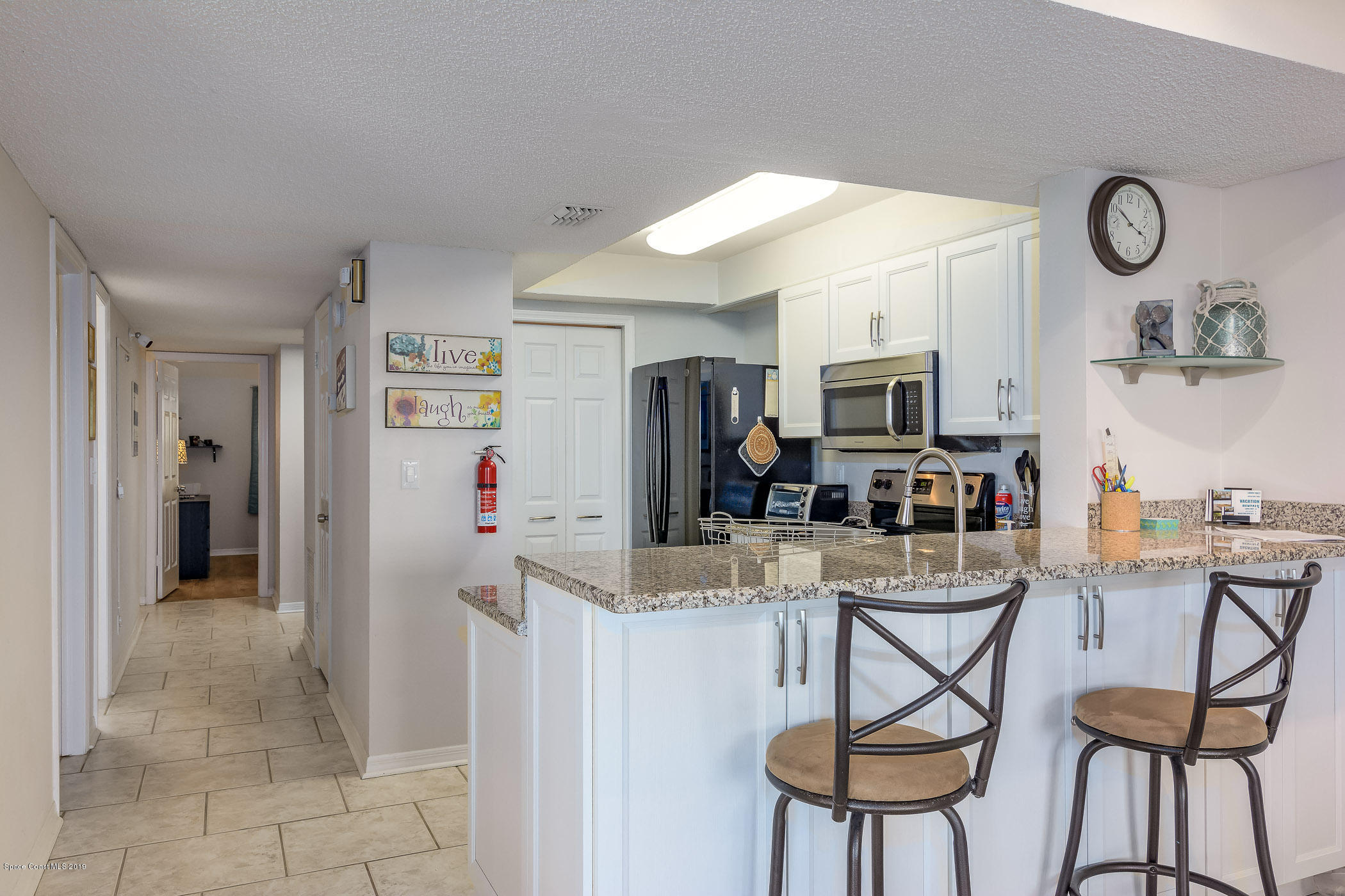 4570 Ocean Beach Boulevard, Unit 106 Cocoa Beach, FL 32931 - Photo 11 of 39 a view of a dining room with furniture and a kitchen