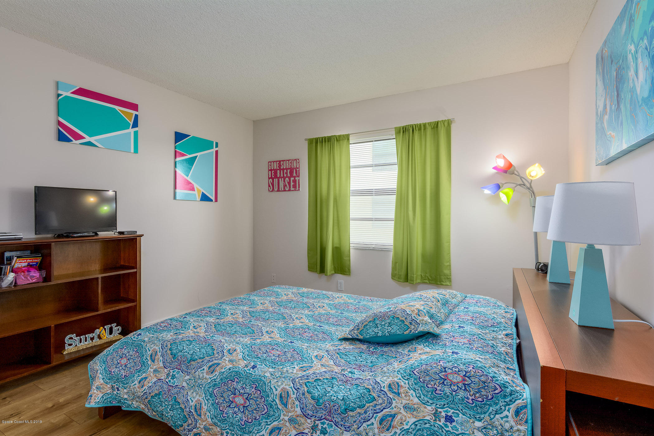 4570 Ocean Beach Boulevard, Unit 106 Cocoa Beach, FL 32931 - Photo 12 of 39 a bedroom with a bed and a television