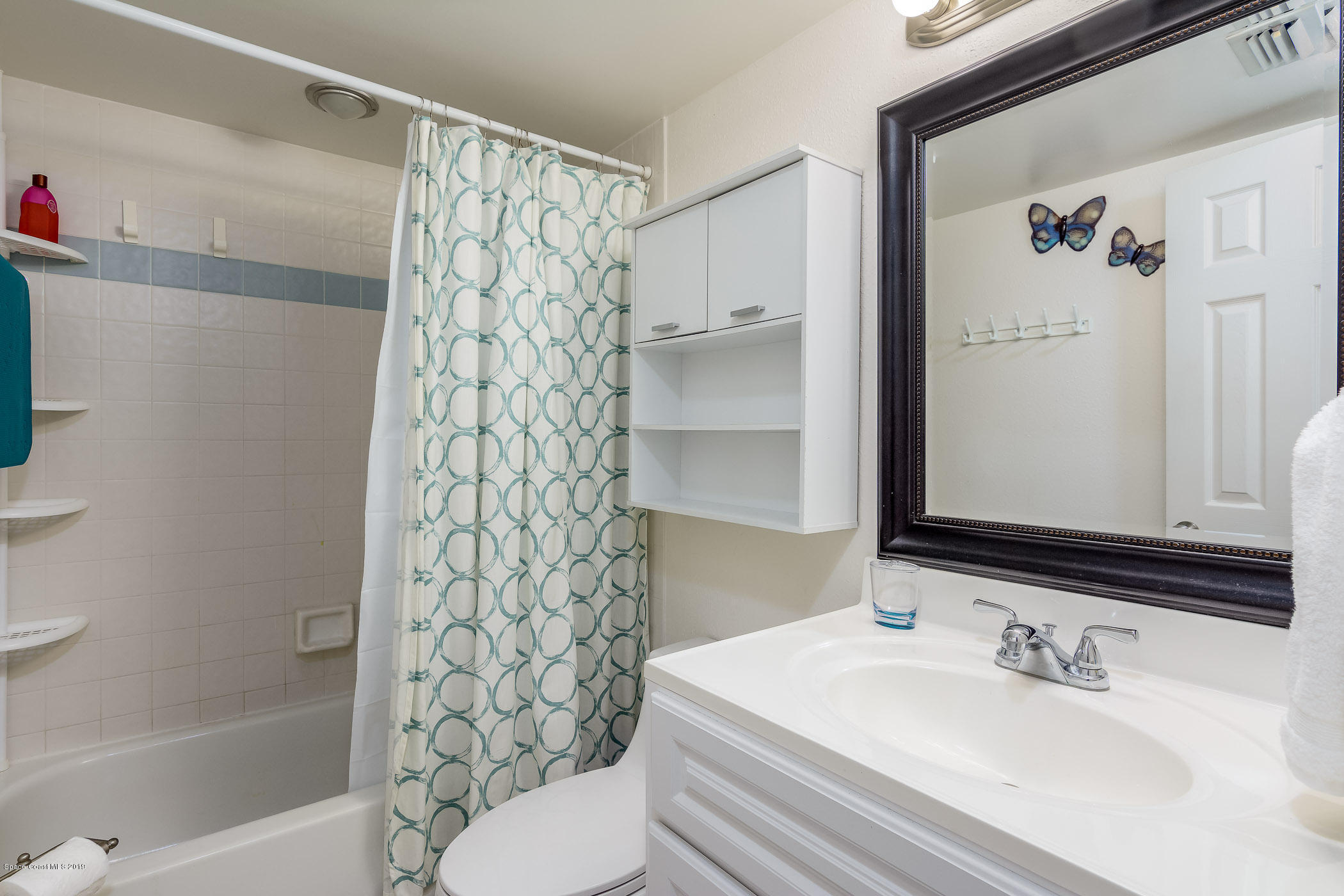 4570 Ocean Beach Boulevard, Unit 106 Cocoa Beach, FL 32931 - Photo 13 of 39 a bathroom with a sink a toilet and shower