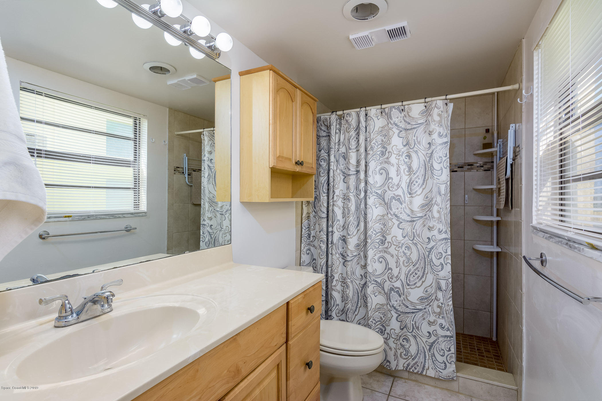 4570 Ocean Beach Boulevard, Unit 106 Cocoa Beach, FL 32931 - Photo 14 of 39 a bathroom with a sink toilet and shower