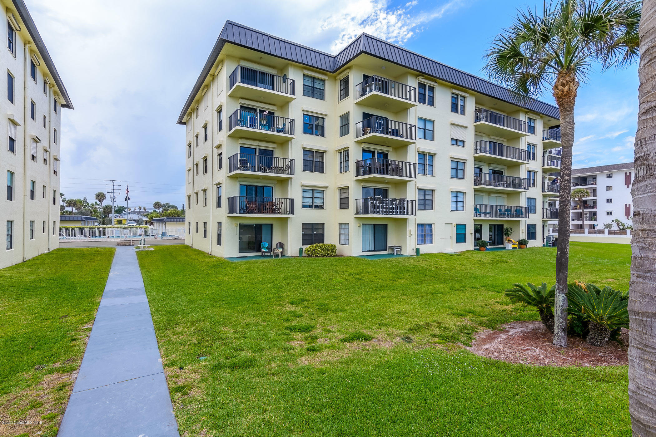 4570 Ocean Beach Boulevard, Unit 106 Cocoa Beach, FL 32931 - Photo 16 of 39 a view of building with garden