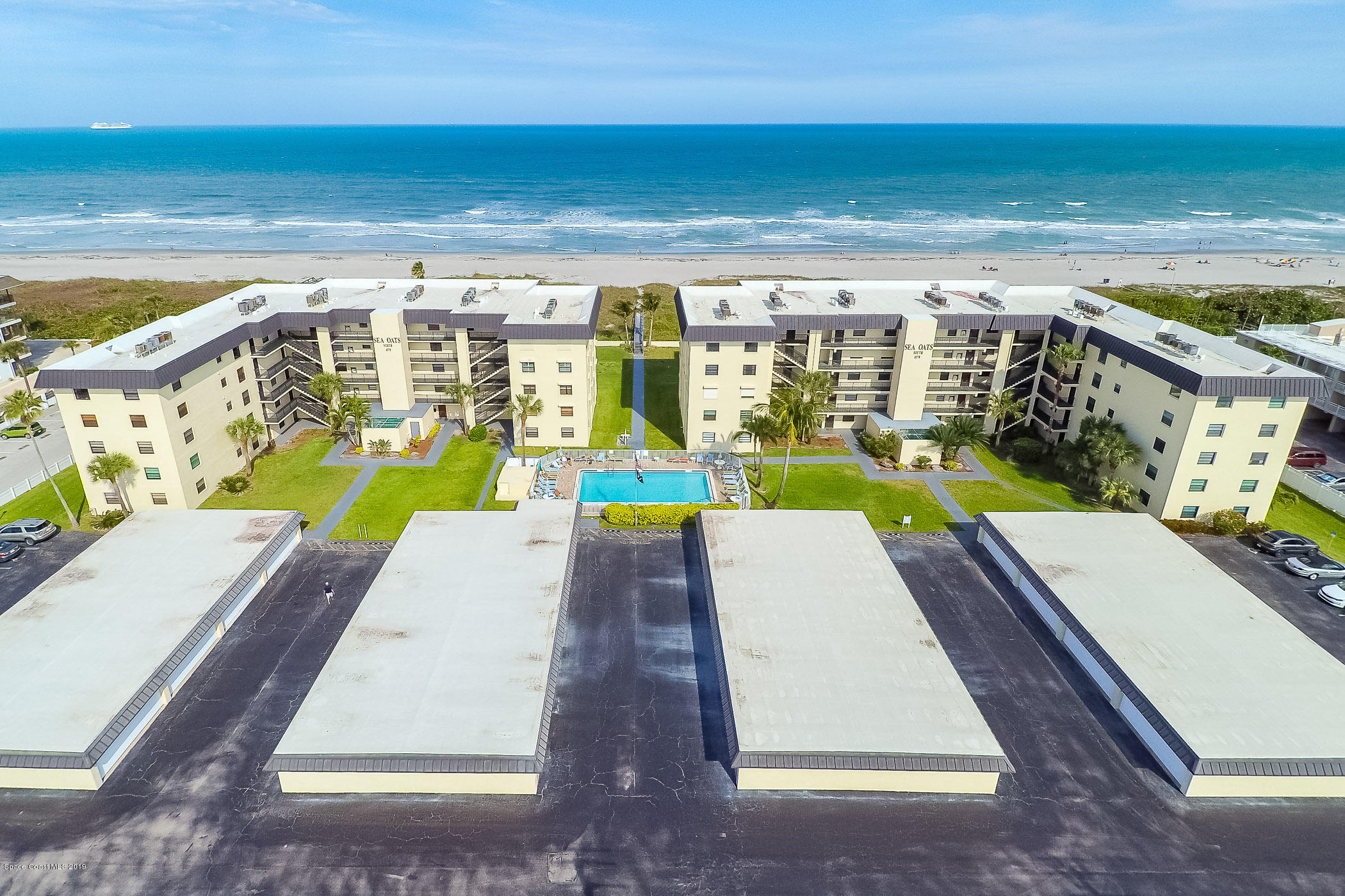 4570 Ocean Beach Boulevard, Unit 106 Cocoa Beach, FL 32931 - Photo 24 of 39 a view of swimming pool with lounge chair