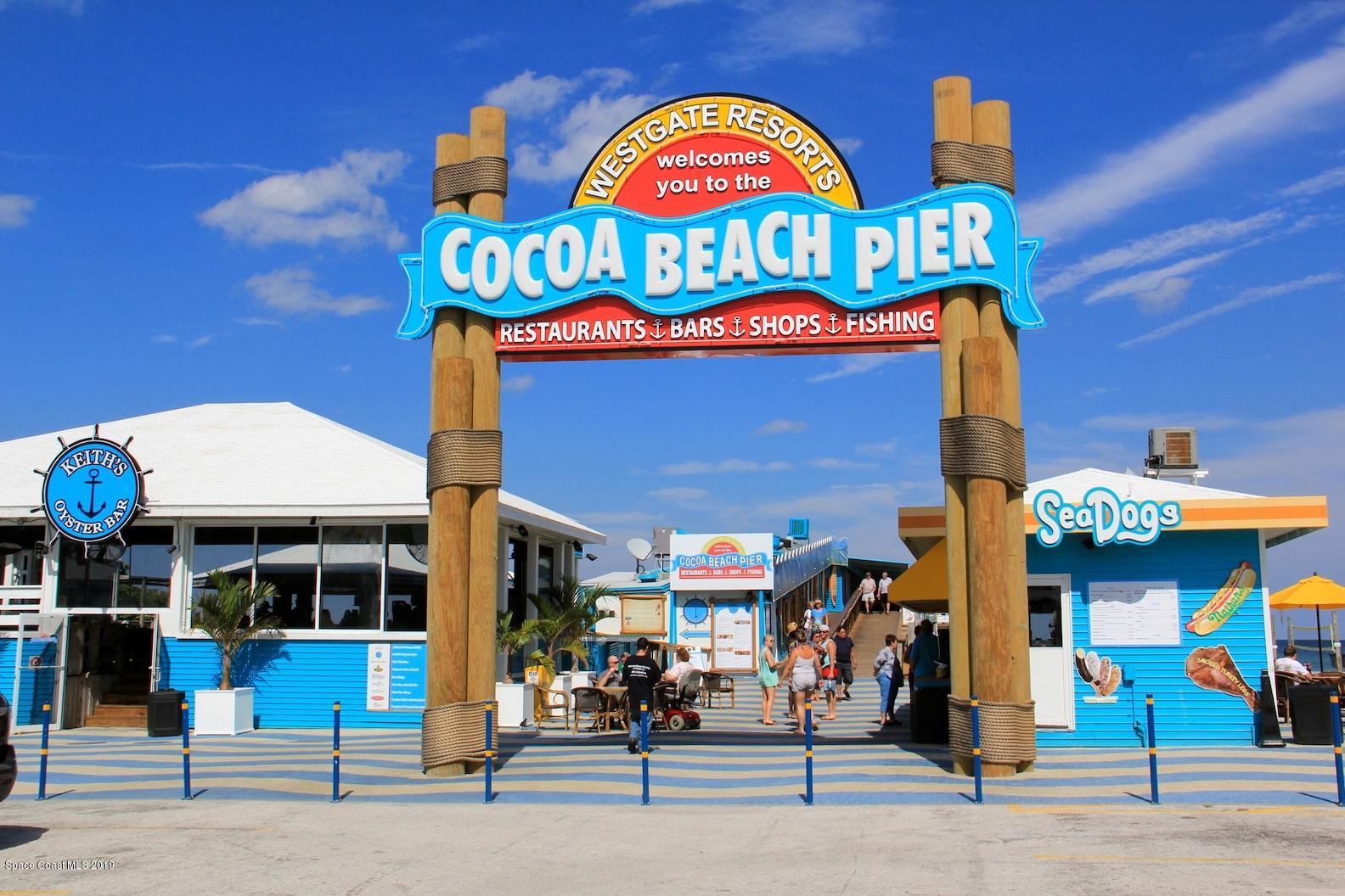 4570 Ocean Beach Boulevard, Unit 106 Cocoa Beach, FL 32931 - Photo 32 of 39 a group of people sitting outside of a building