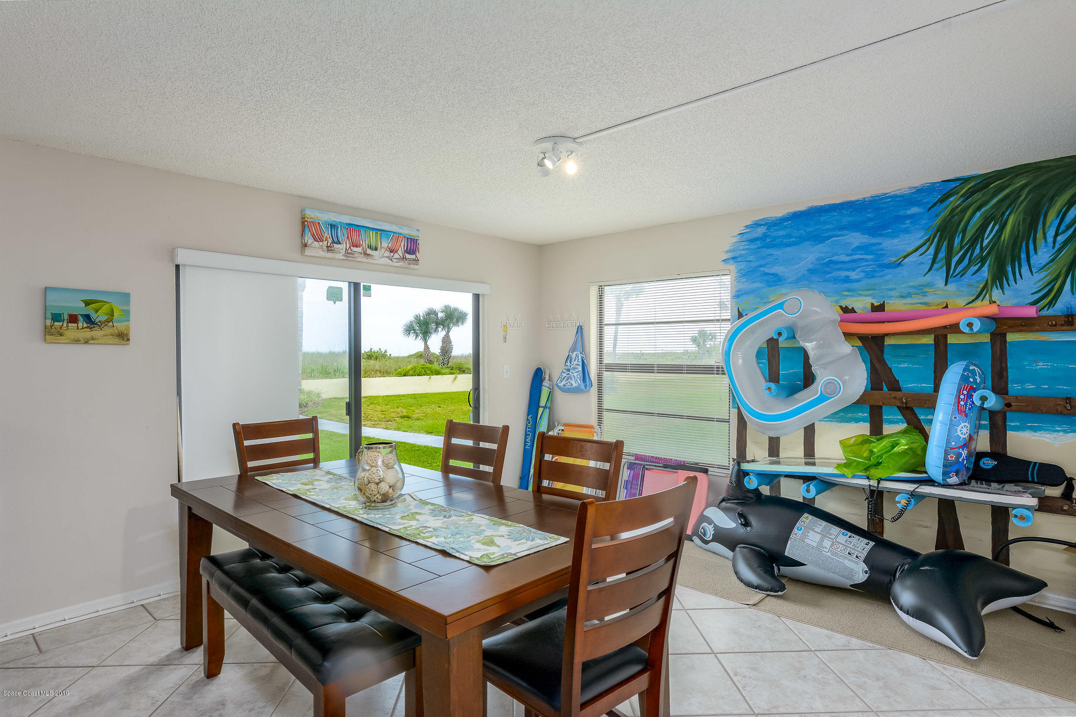 4570 Ocean Beach Boulevard, Unit 106 Cocoa Beach, FL 32931 - Photo 5 of 39 a living room with furniture and wooden floor