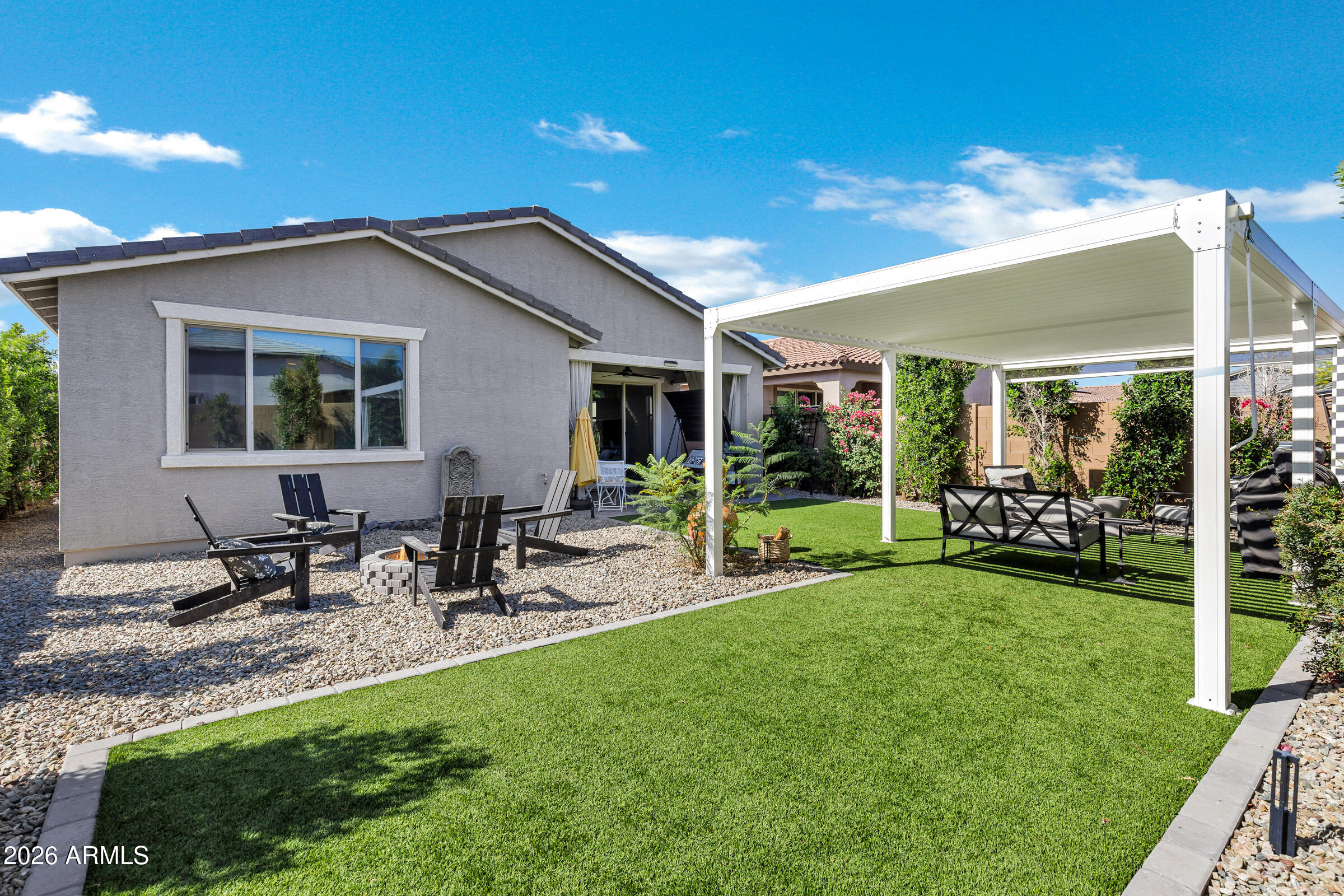 12243 East Sereno Road Gold Canyon, AZ 85118 - Photo 36 of 37 a view of a patio with table and chairs under an umbrella