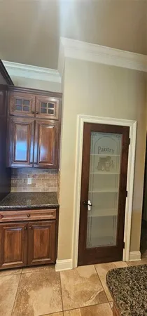 a kitchen with stainless steel appliances granite countertop a refrigerator a stove and a wooden floors