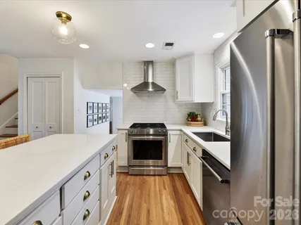 a kitchen with a stove sink and refrigerator