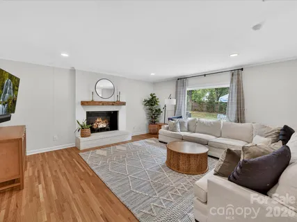 a living room with furniture a window and a fireplace