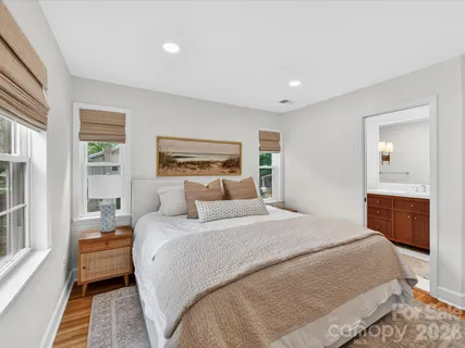 a bedroom with a large bed and a couch