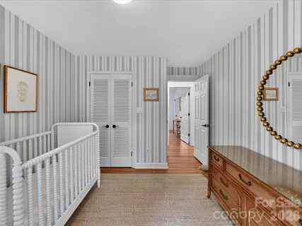 a view of a bedroom with wooden floor