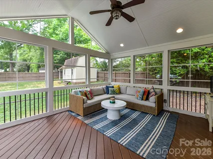 a living room with furniture and a floor to ceiling window