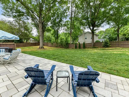 a view of a chair and table on the garden