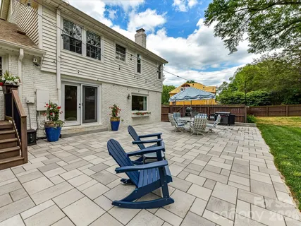 a view of a patio with dining table and chairs with a fire pit
