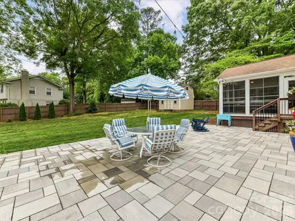 a view of a house with backyard porch and sitting area