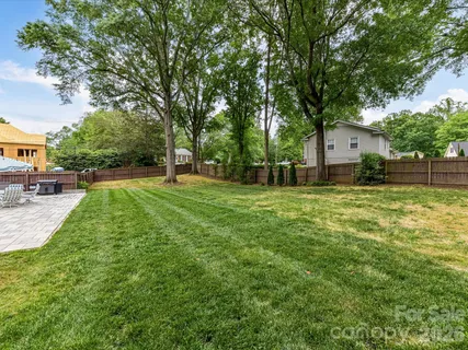 a swimming pool with outdoor seating and yard