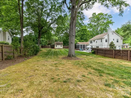 a view of a house with a backyard