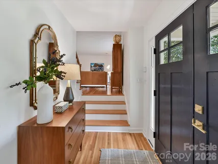 a view of entryway and hall with wooden floor