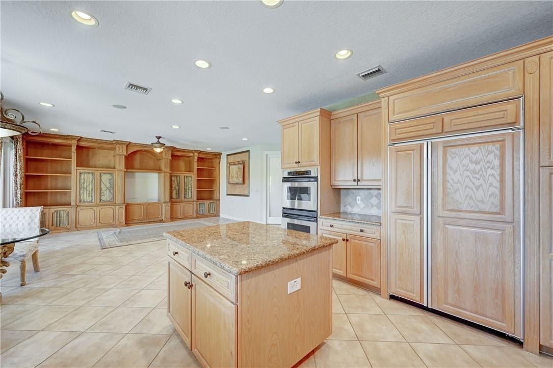 19168 Skyridge Circle Boca Raton, FL 33498 - Photo 15 of 55 a kitchen with kitchen island granite countertop counter top space and stainless steel appliances