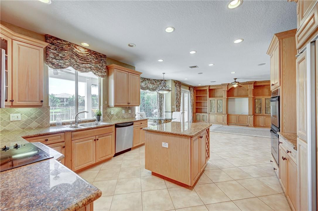 19168 Skyridge Circle Boca Raton, FL 33498 - Photo 16 of 55 a large kitchen with kitchen island granite countertop a large counter top and stainless steel appliances