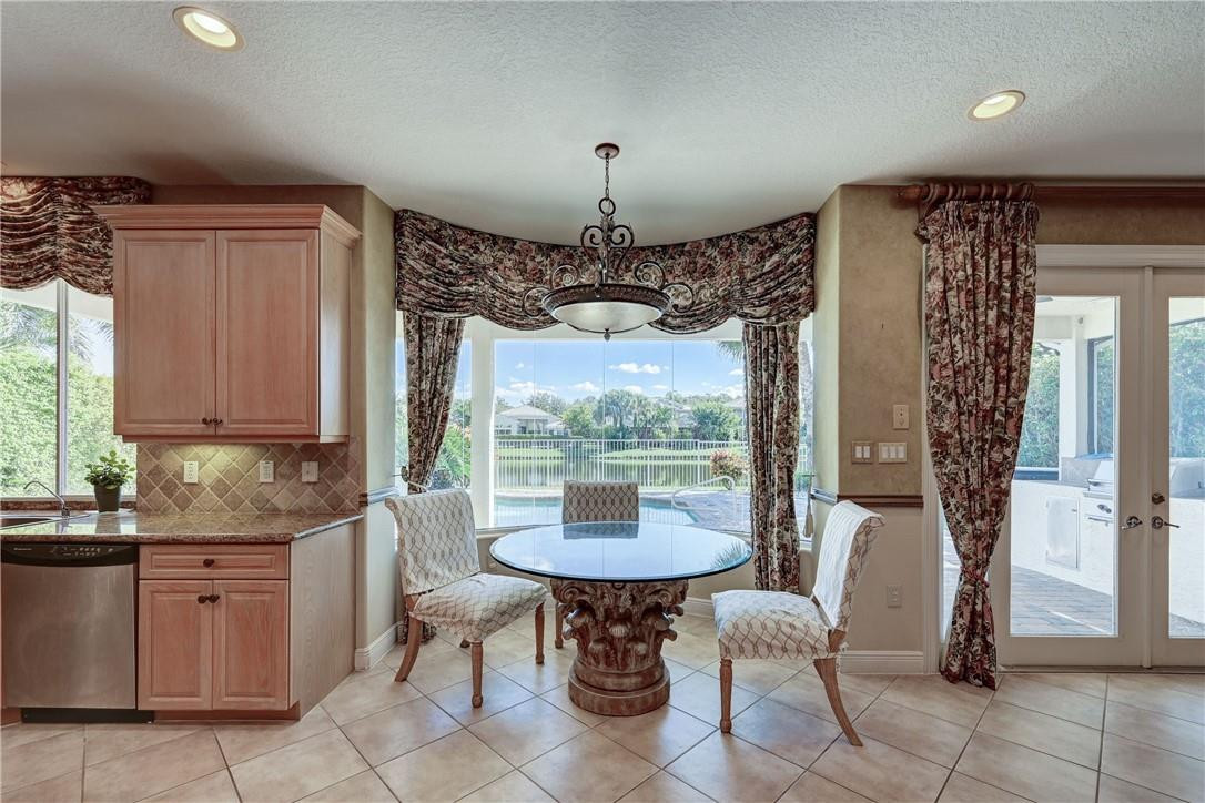 19168 Skyridge Circle Boca Raton, FL 33498 - Photo 17 of 55 a dining room with furniture and a chandelier