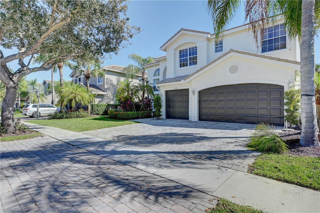 19168 Skyridge Circle Boca Raton, FL 33498 - Photo 3 of 55 a front view of a house with a yard and garage