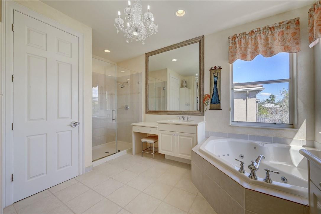 19168 Skyridge Circle Boca Raton, FL 33498 - Photo 32 of 55 a bathroom with a tub a sink and a shower