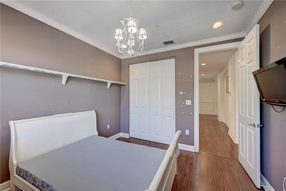 19168 Skyridge Circle Boca Raton, FL 33498 - Photo 34 of 55 a bedroom with a bed and a chandelier