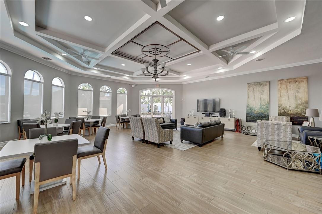 19168 Skyridge Circle Boca Raton, FL 33498 - Photo 51 of 55 a living room with furniture and a chandelier