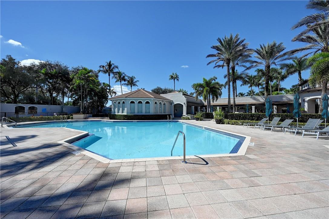19168 Skyridge Circle Boca Raton, FL 33498 - Photo 52 of 55 a view of a swimming pool with a lounge chairs