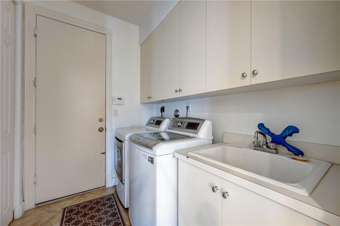 19168 Skyridge Circle Boca Raton, FL 33498 - Photo 8 of 55 a utility room with sink dryer and washer