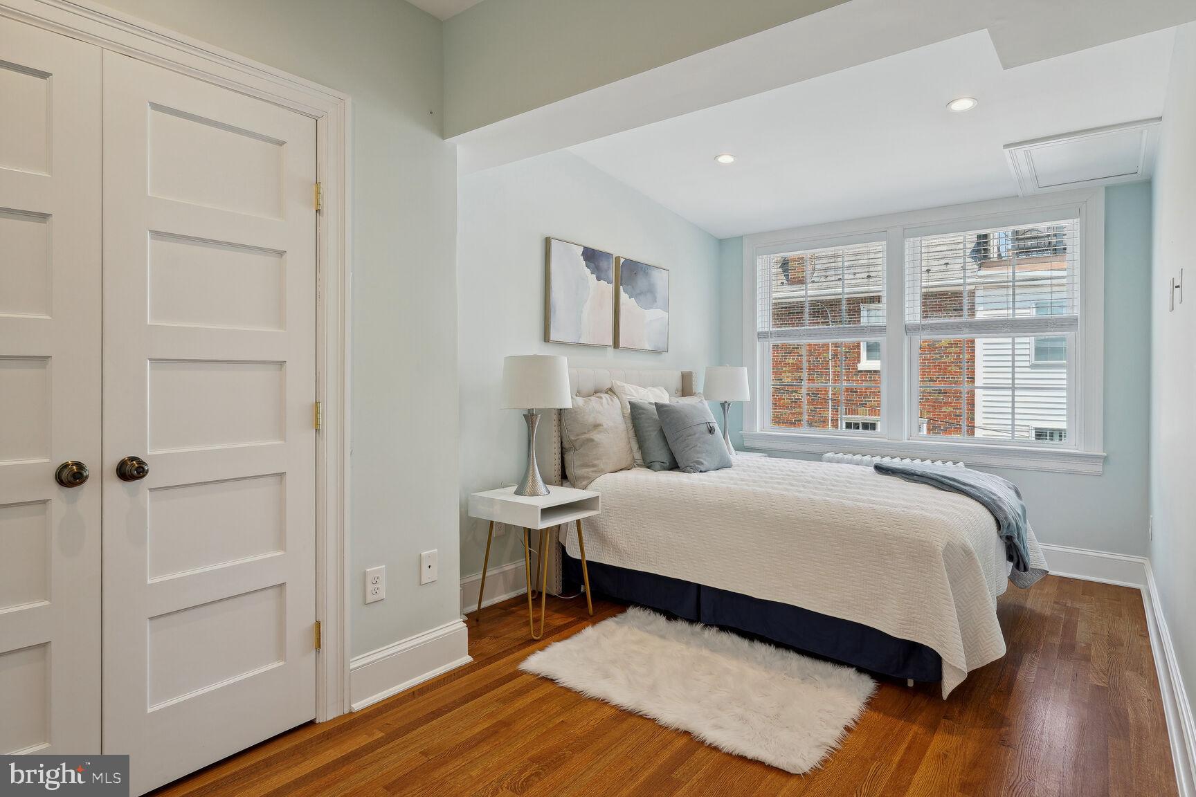 3863 Beecher Street Northwest Washington, DC 20007 - Photo 16 of 19 a bedroom with a bed and wooden floor