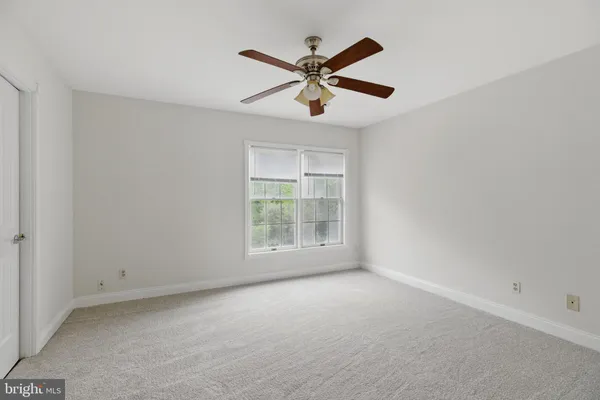 a view of room with window and ceiling fan