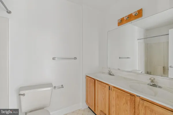a bathroom with a sink and mirror with toilet