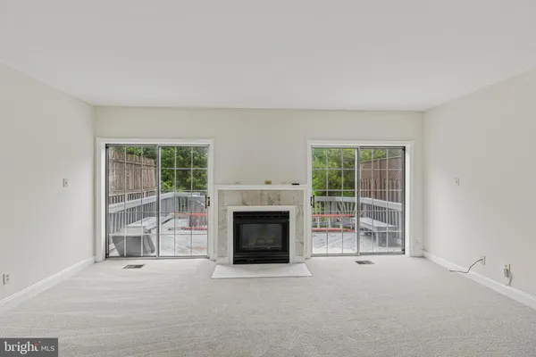 an empty room with furniture and a fireplace