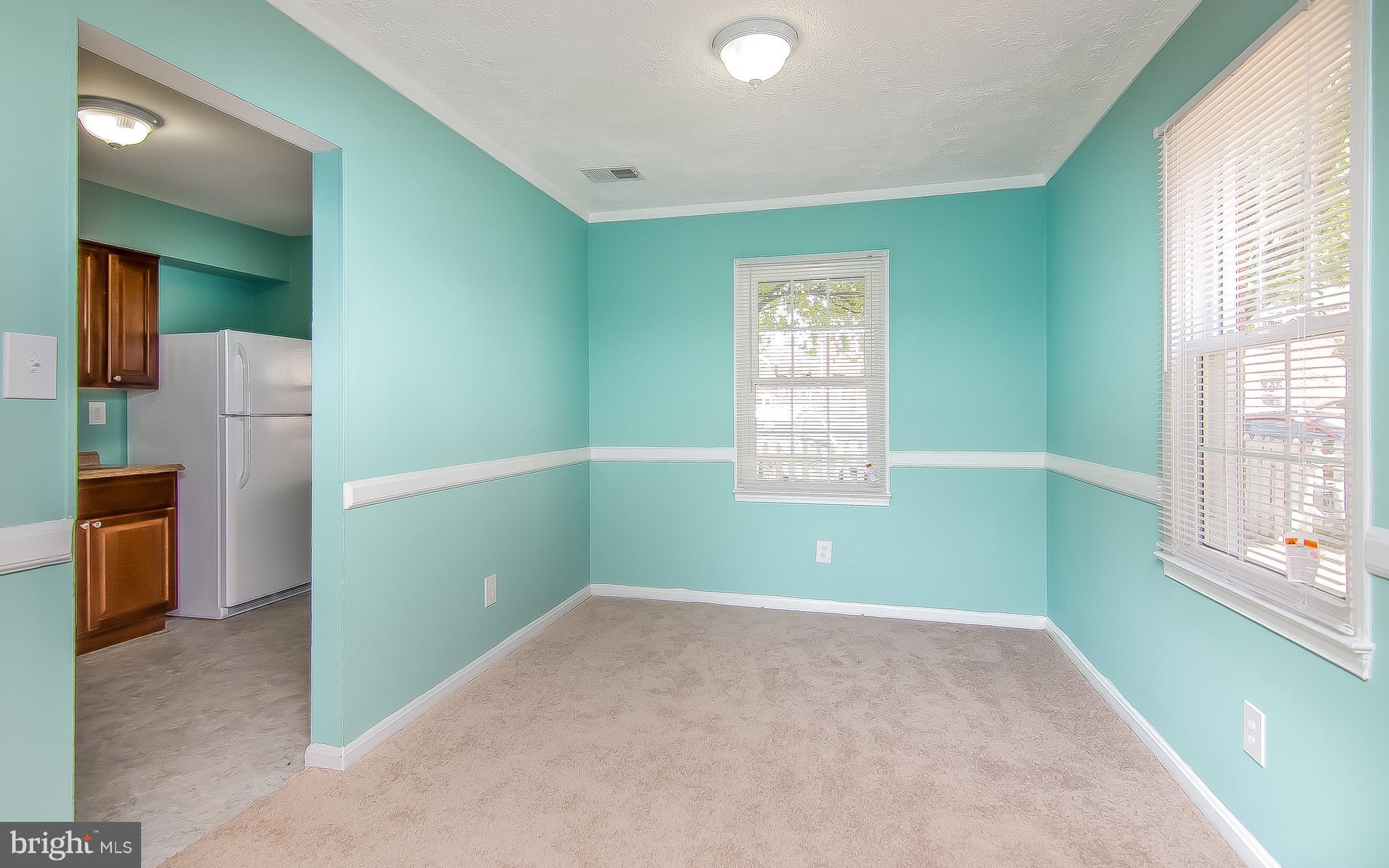 9845 Buckner Road Manassas, VA 20110 - Photo 7 of 19 a view of empty room with a window and a kitchen
