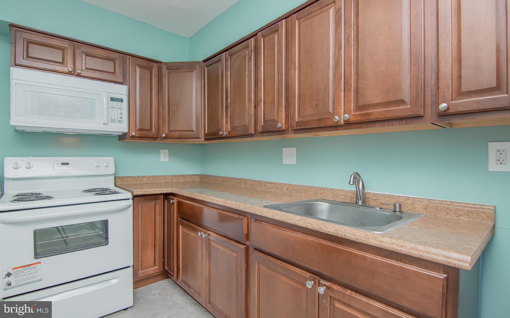 9845 Buckner Road Manassas, VA 20110 - Photo 9 of 19 a kitchen with granite countertop a sink stainless steel appliances and cabinets