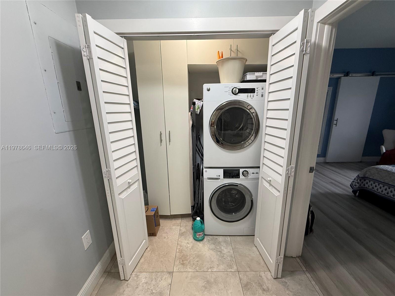 13833 Southwest 157th Street Miami, FL 33177 - Photo 18 of 25 a view of a storage and utility room with washer and dryer