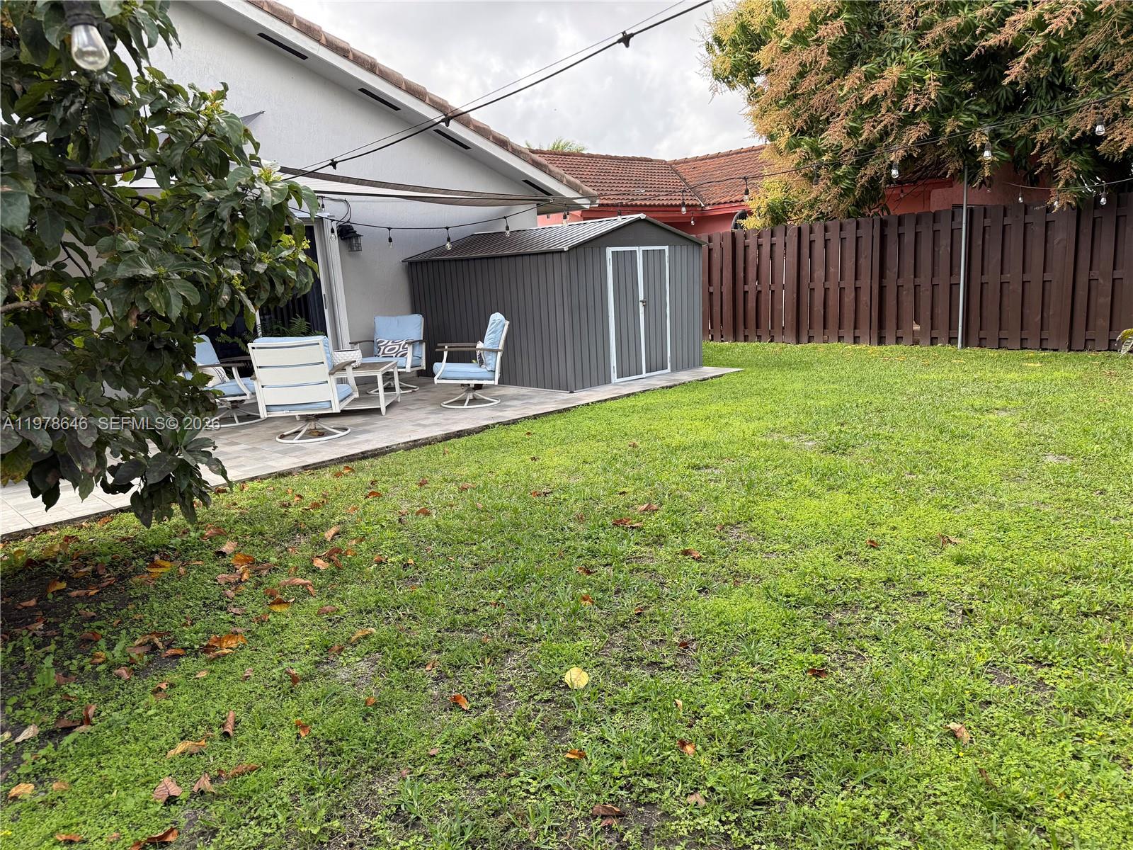 13833 Southwest 157th Street Miami, FL 33177 - Photo 23 of 25 a backyard of a house with table and chairs