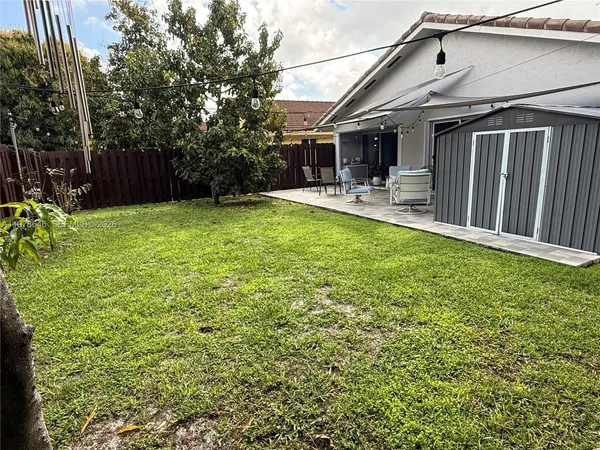 a backyard of a house with yard and outdoor seating
