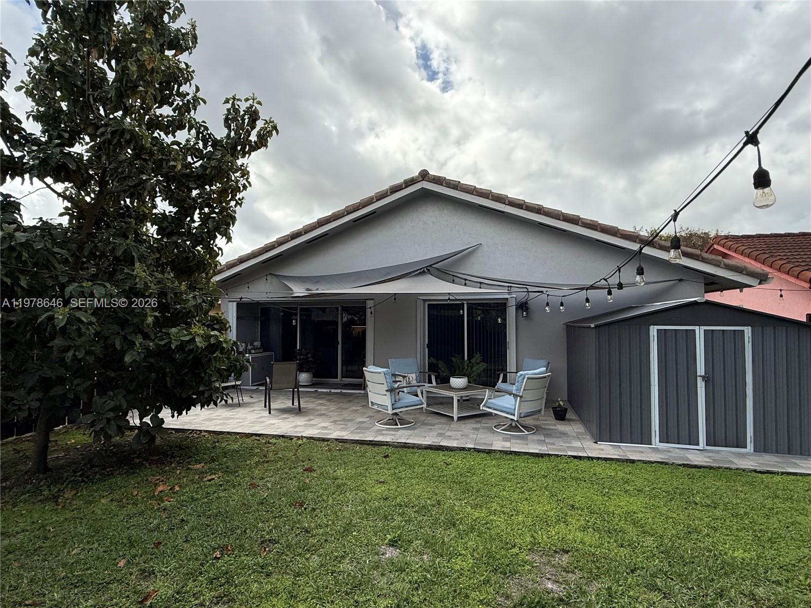 13833 Southwest 157th Street Miami, FL 33177 - Photo 25 of 25 a backyard of a house with yard table and chairs